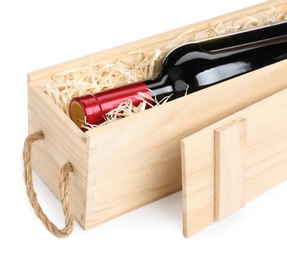 Photo of Open wooden crate with bottle of wine isolated on white, closeup