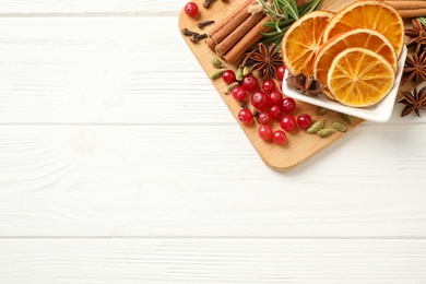 Photo of Flat lay composition with mulled wine ingredients on white wooden table. Space for text