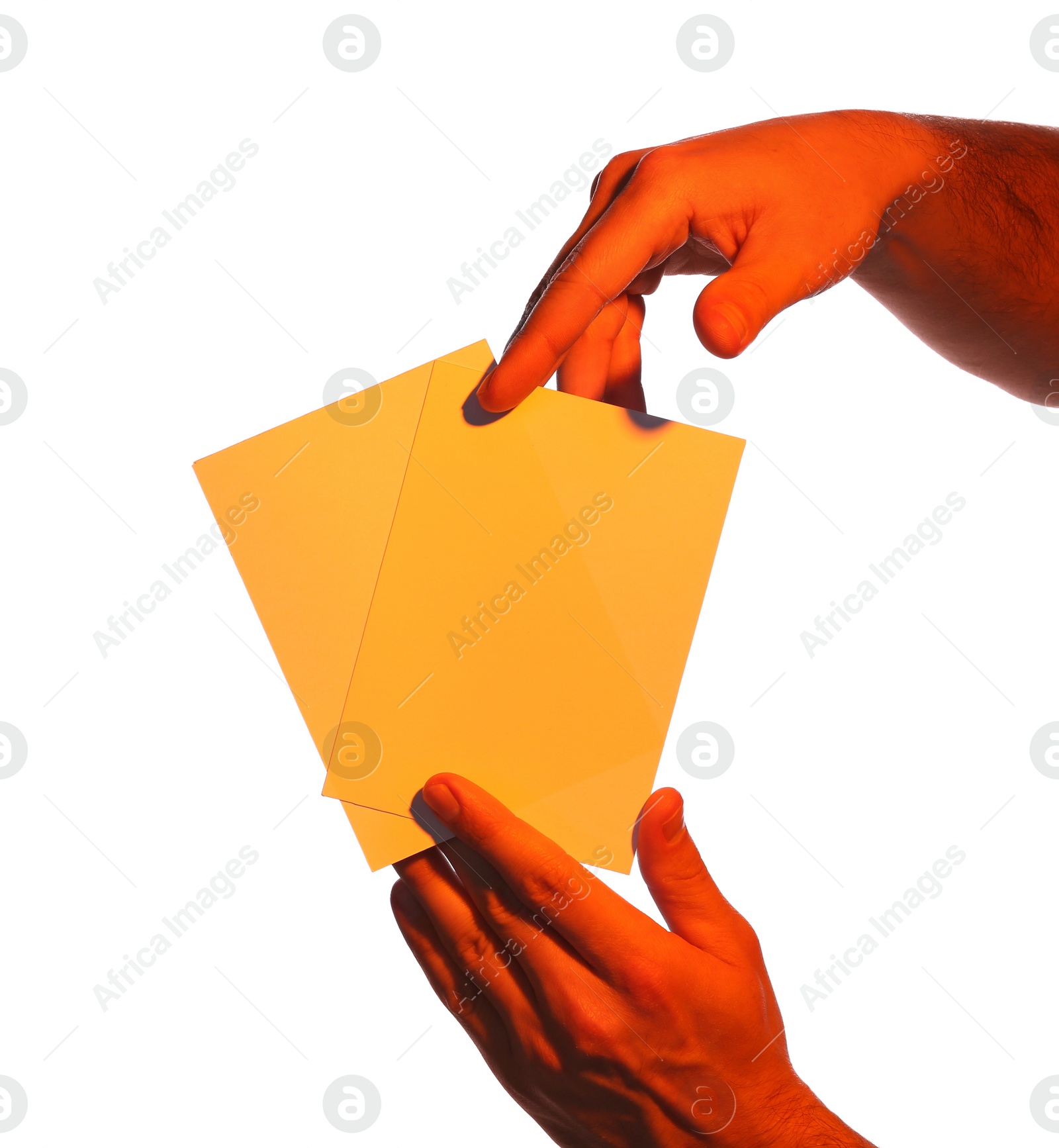 Photo of Man holding orange flyers on white background, closeup. Mockup for design