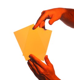Photo of Man holding orange flyers on white background, closeup. Mockup for design