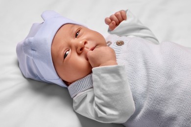 Cute newborn baby lying on white blanket