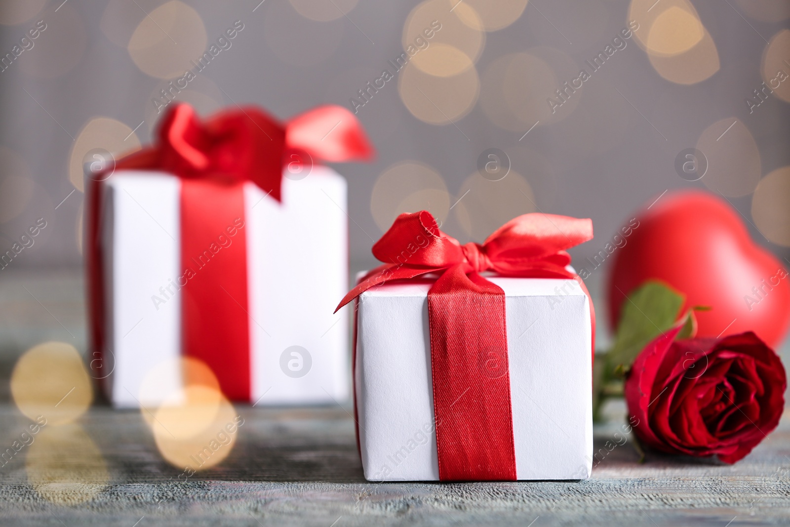 Photo of Beautiful gift boxes on wooden table, space for text. Valentine's Day celebration