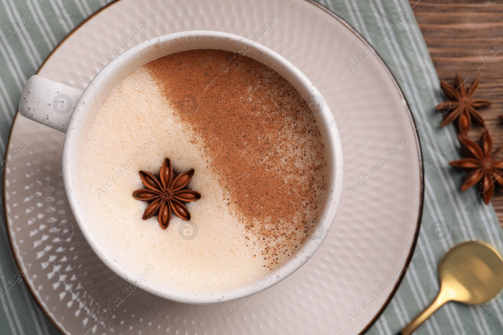 Photo of Cup of delicious eggnog with anise on wooden table, top view