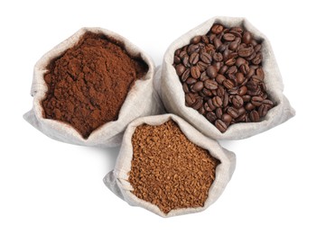 Bags with different types of coffee on white background, top view