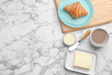 Photo of Plate of fresh croissant served on white marble table, flat lay with space for text. French pastry