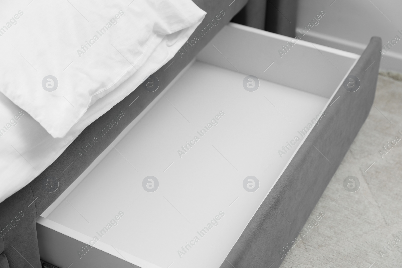 Photo of Storage drawer for bedding under modern bed in room