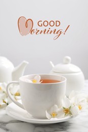 Image of Aromatic jasmine tea and fresh flowers on white marble table. Good morning