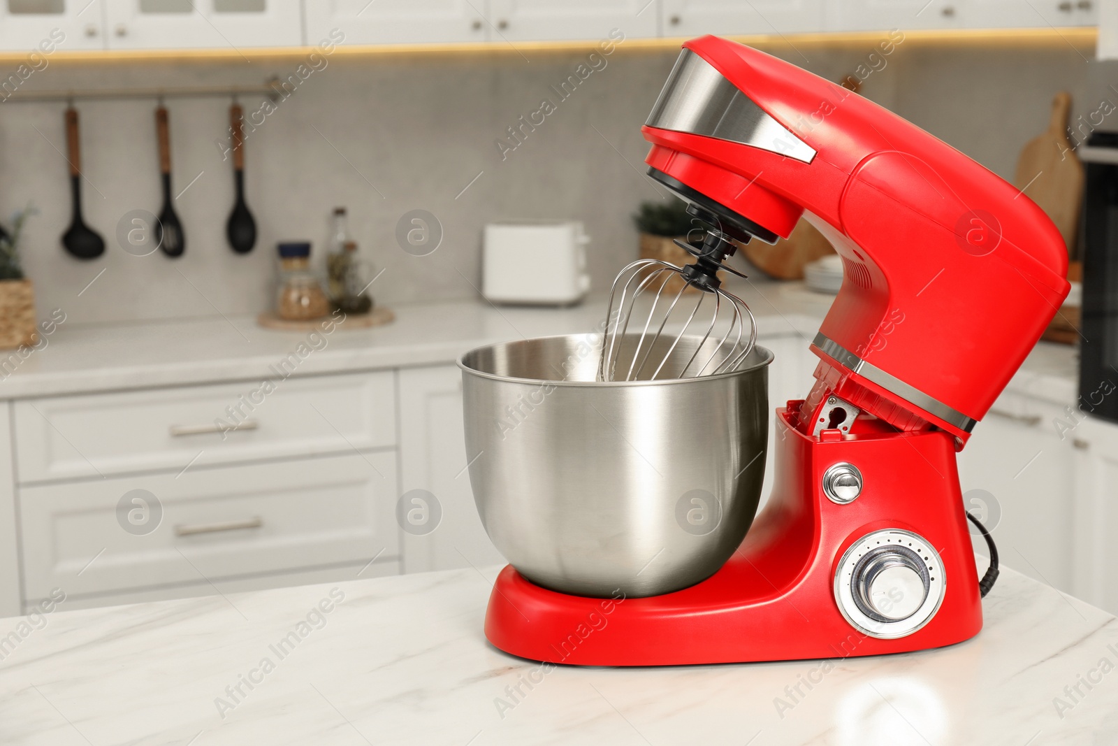 Photo of Modern red stand mixer on white marble table in kitchen, space for text