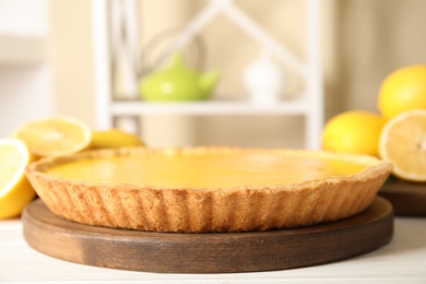 Delicious homemade lemon pie on white wooden table, space for text