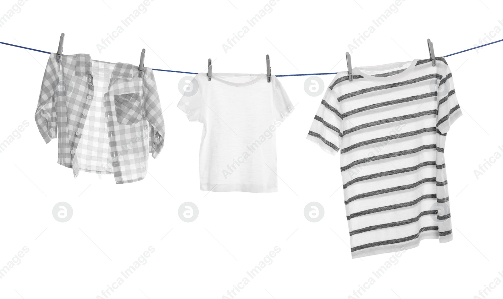 Photo of Different clothes drying on washing line against white background