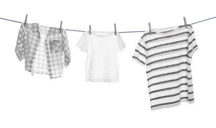 Different clothes drying on washing line against white background