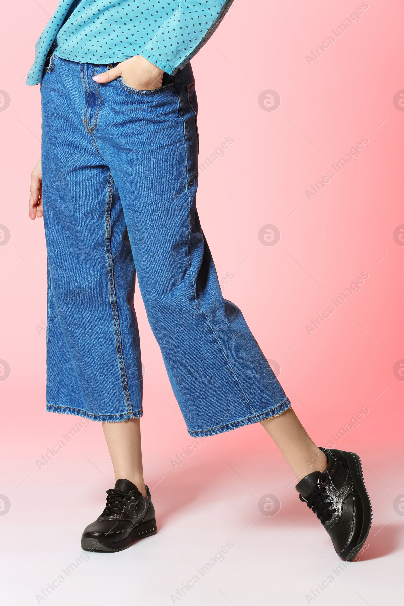 Photo of Fashionable woman in stylish shoes on color background