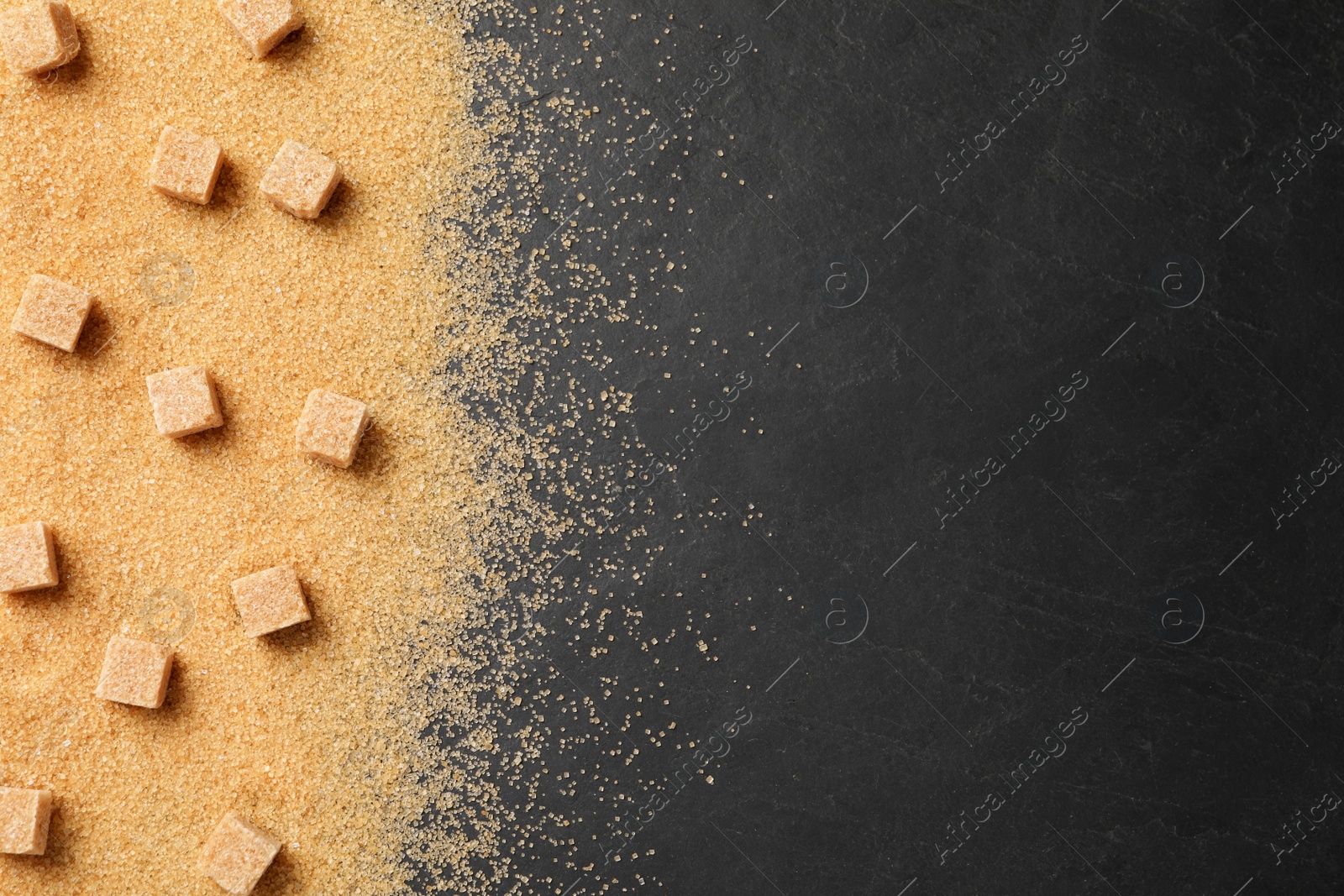 Photo of Brown sugar on black table, flat lay. Space for text