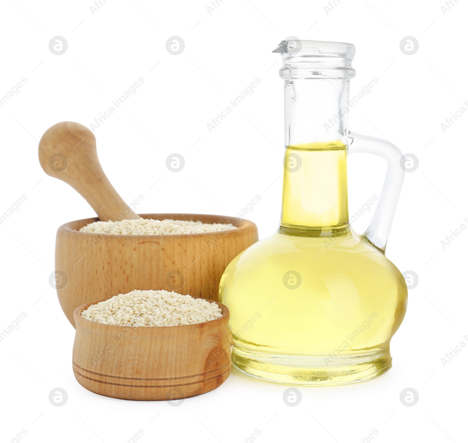 Photo of Glass jug of fresh sesame oil and seeds isolated on white