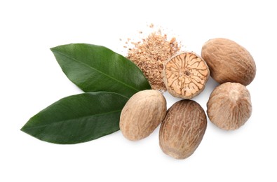 Photo of Grated nutmeg and seeds with green leaves on white background