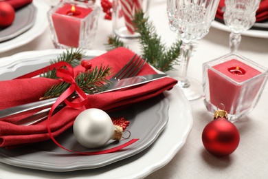 Festive table setting with beautiful dishware and Christmas decor on white background