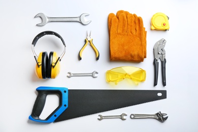 Photo of Flat lay composition with different construction tools on white background