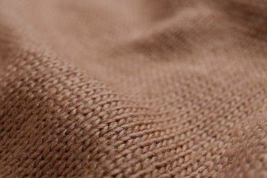 Brown knitted fabric as background, closeup view