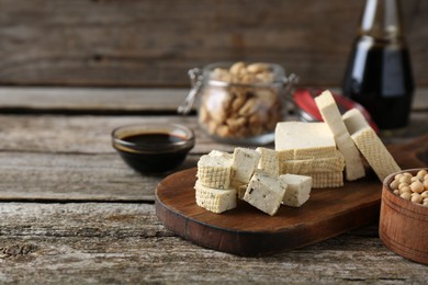 Photo of Different natural soy products on wooden table, space for text