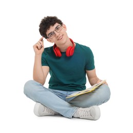 Photo of Portrait of student with notebook and headphones sitting on white background