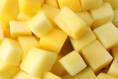 Many delicious mango cubes as background, closeup