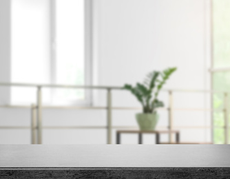 Image of Empty grey stone surface and blurred view of modern room 