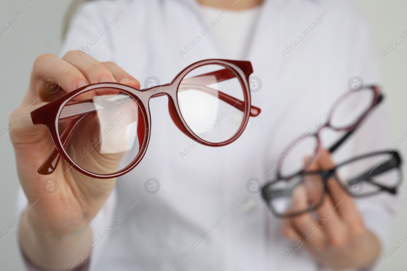 Photo of Woman with different glasses on light background, closeup