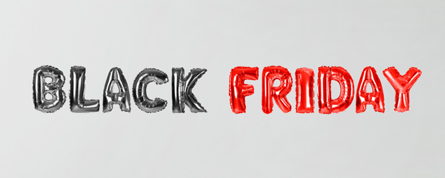Image of Phrase BLACK FRIDAY made of foil balloon letters on white background. Banner design