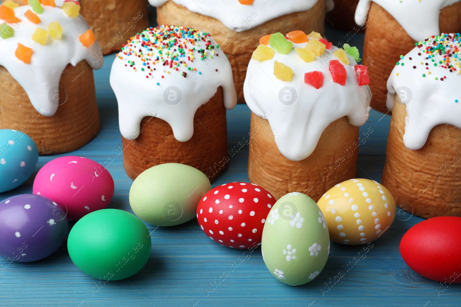 Photo of Traditional Easter cakes and dyed eggs on wooden table