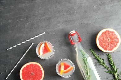 Photo of Flat lay composition with cocktails, grapefruits and space for text on grey table