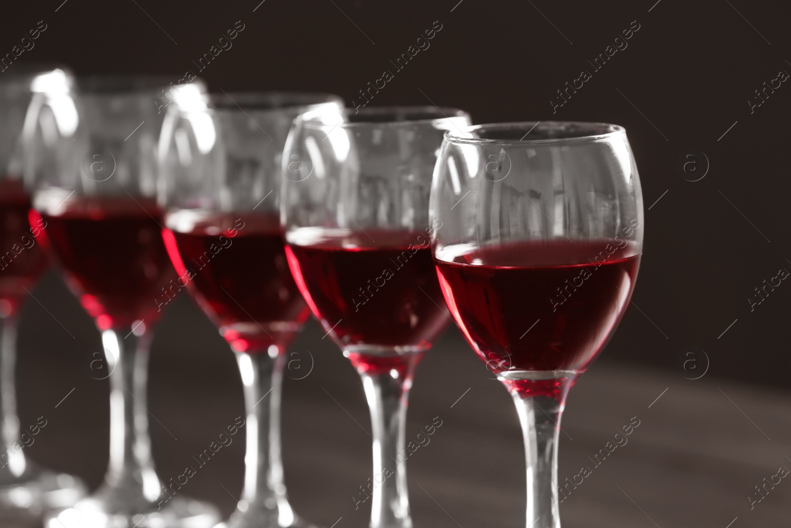 Photo of Glasses with delicious red wine, closeup