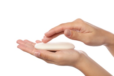 Woman holding soap bar on white background, closeup