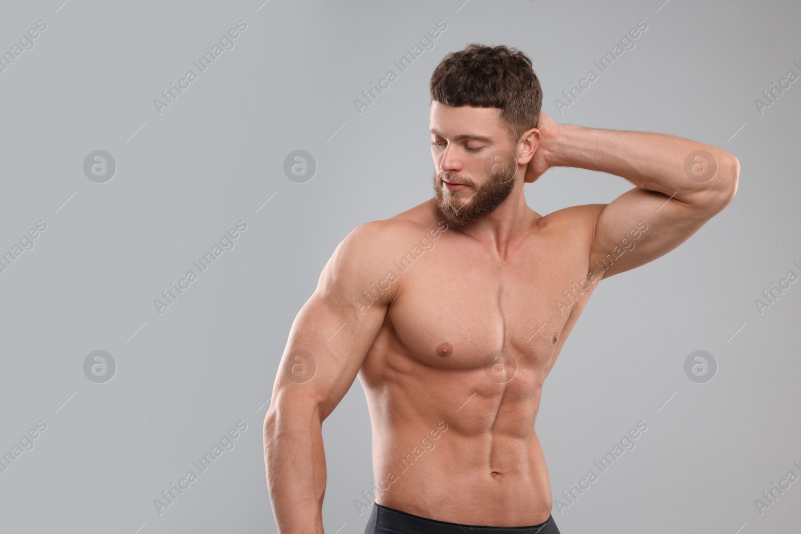 Photo of Handsome muscular man on light grey background. Sexy body