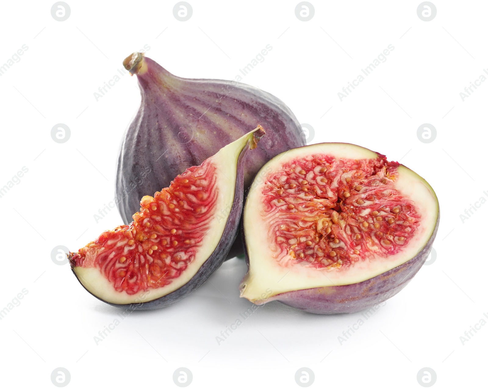 Photo of Whole and cut purple figs on white background