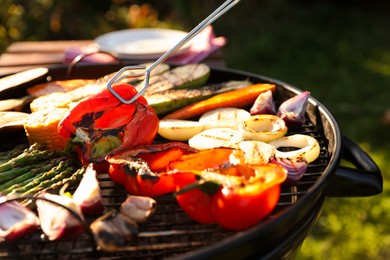 Photo of Delicious grilled vegetables on barbecue grill outdoors