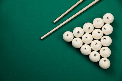 Flat lay composition with balls on billiard table. Space for text