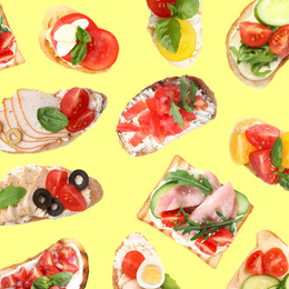 Image of Set of delicious toasted bread with different toppings on yellow background, top view