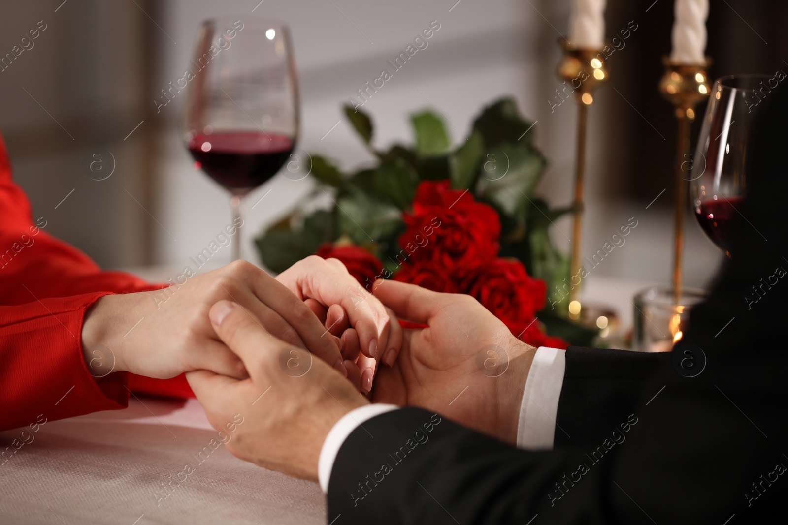 Photo of Couple having romantic dinner on Valentine's day in restaurant, closeup