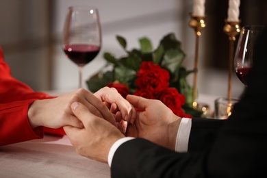 Photo of Couple having romantic dinner on Valentine's day in restaurant, closeup