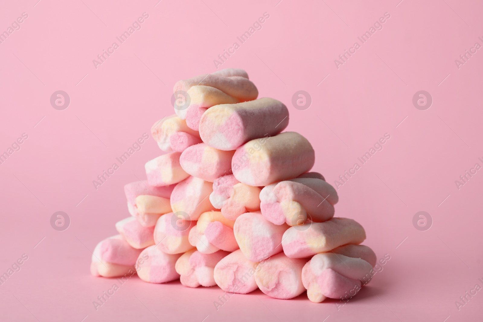 Photo of Stack of tasty marshmallows on pink background