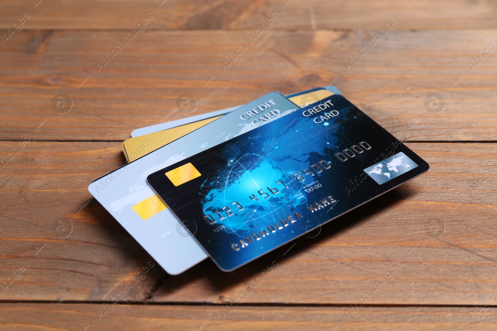 Photo of Many plastic credit cards on wooden table