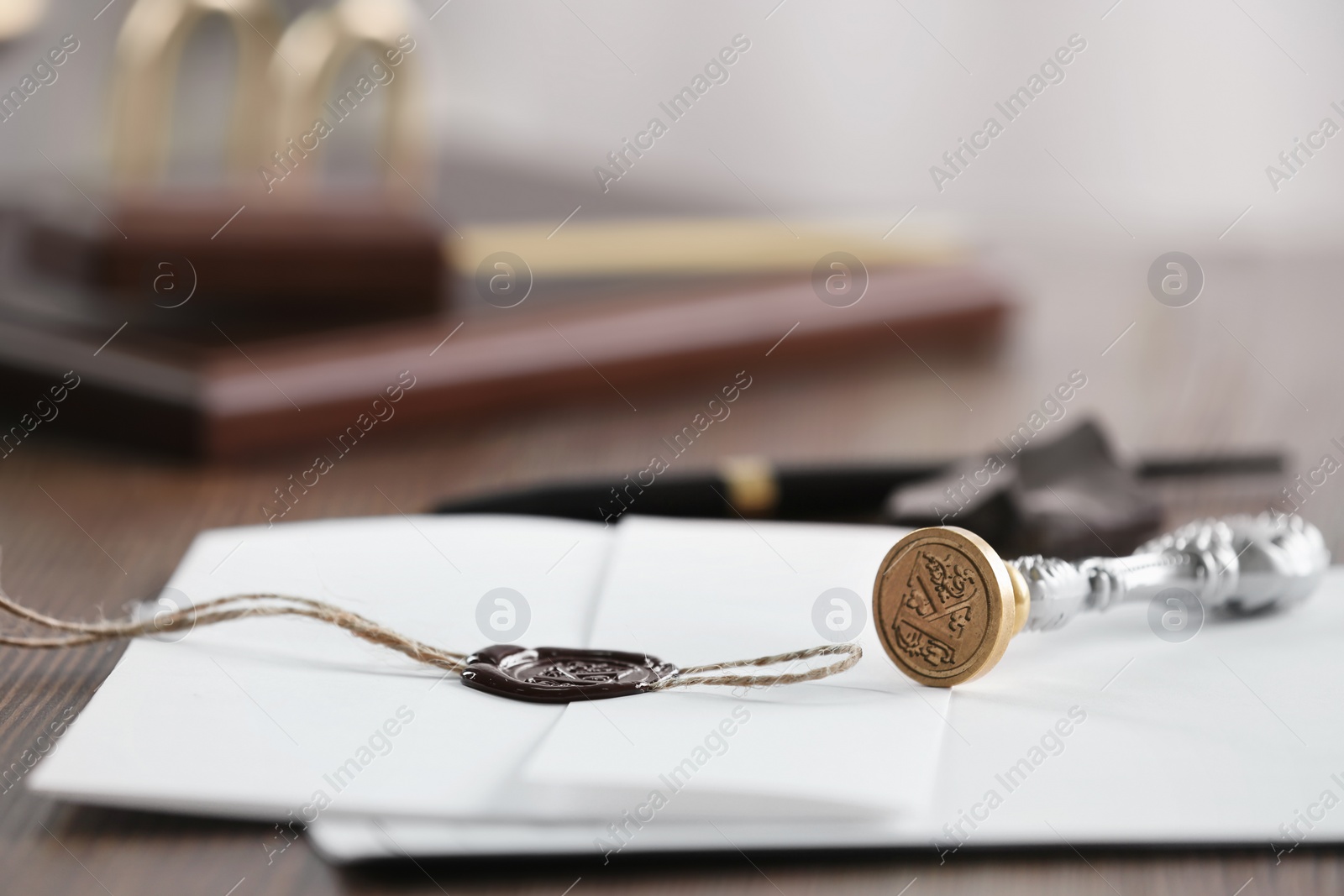 Photo of Vintage notary stamp and documents on wooden table, closeup. Space for text