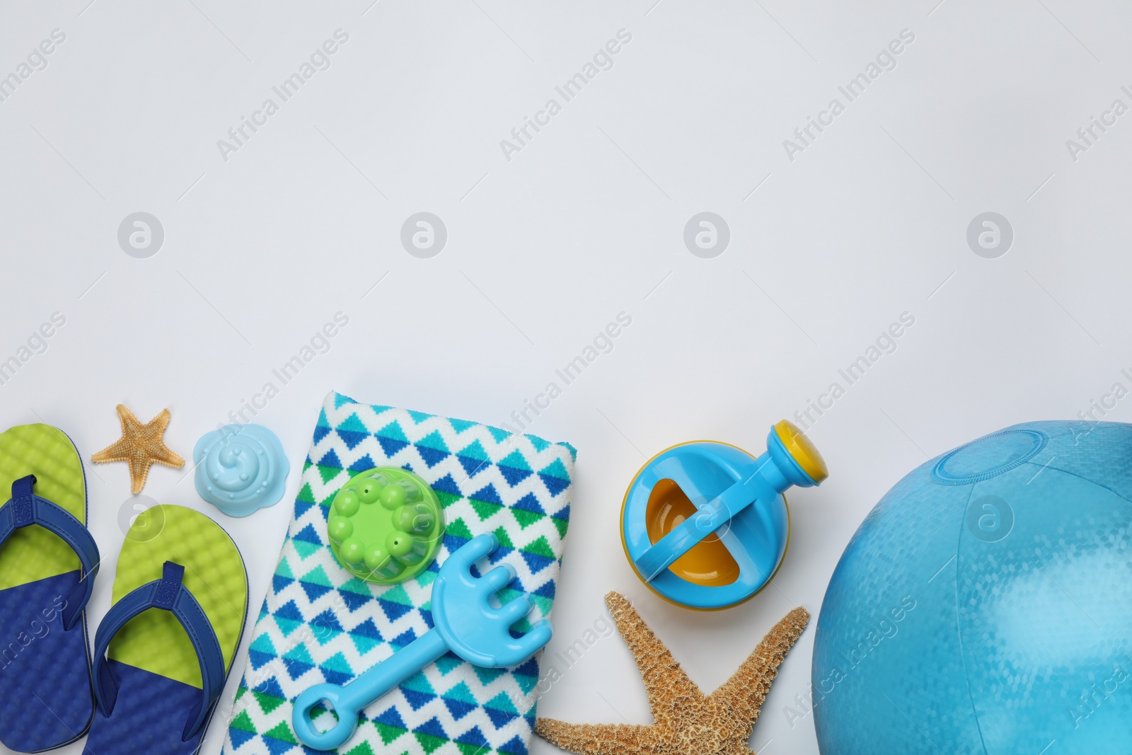 Photo of Flat lay composition with beach ball and sand toys on white background