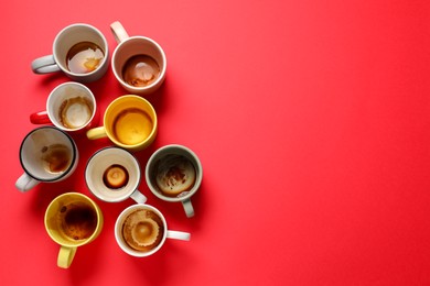 Photo of Many dirty cups after drinking coffee on red table, flat lay. Space for text