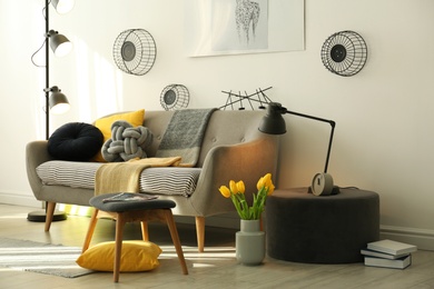 Photo of Stylish living room interior with comfortable sofa. Idea for home decor