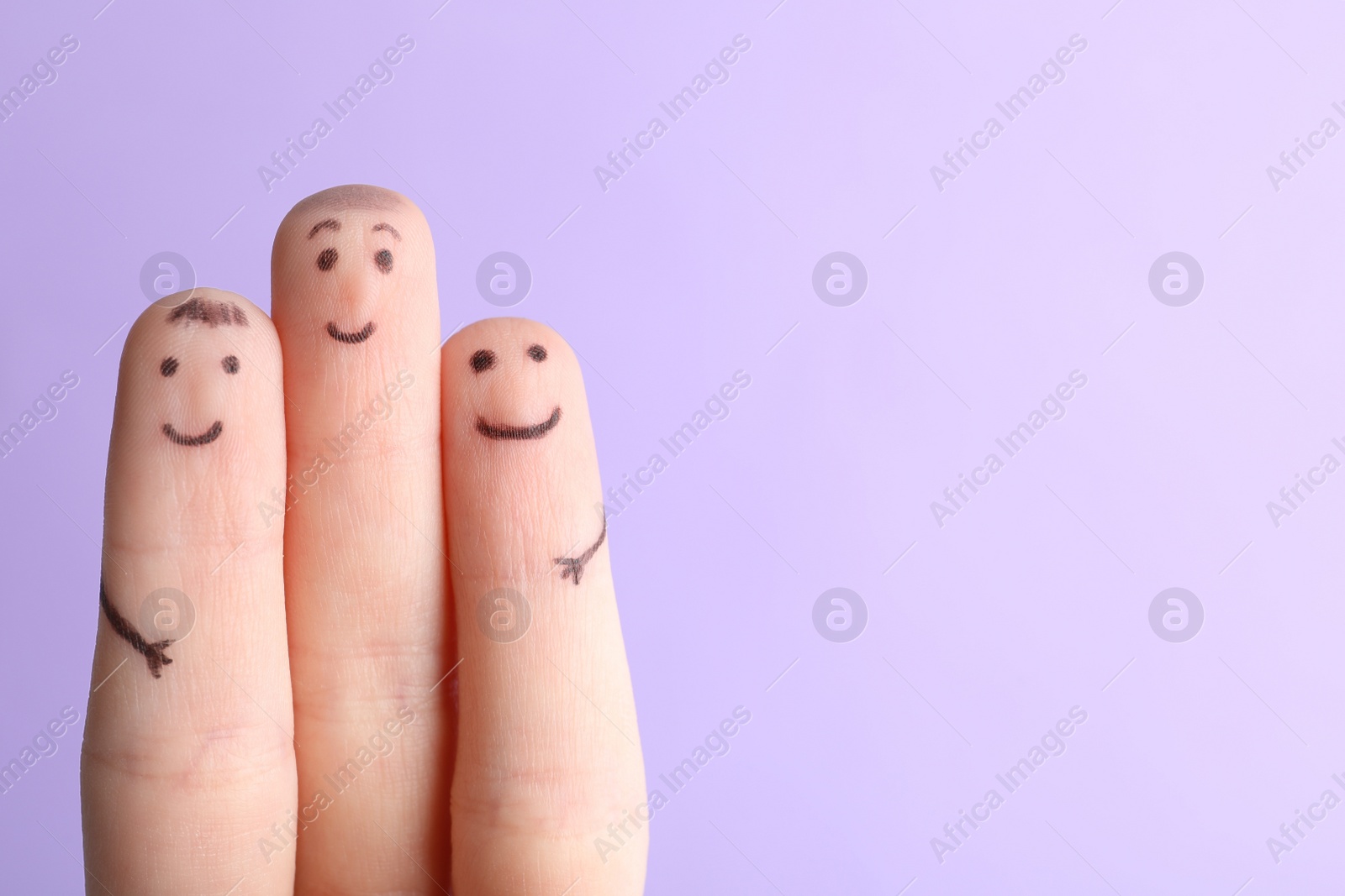 Photo of Three fingers with drawings of happy faces on violet background, space for text