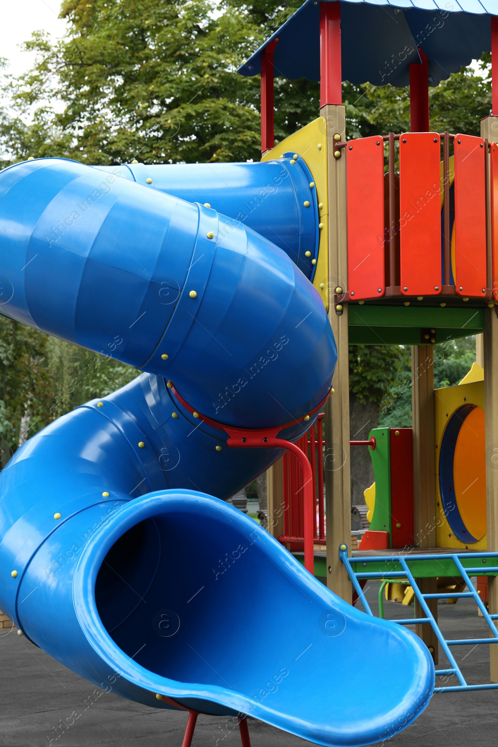 Photo of New colorful castle playhouse with slide on children's playground