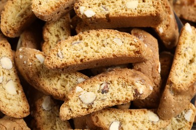 Photo of Traditional Italian almond biscuits (Cantucci) as background, closeup view