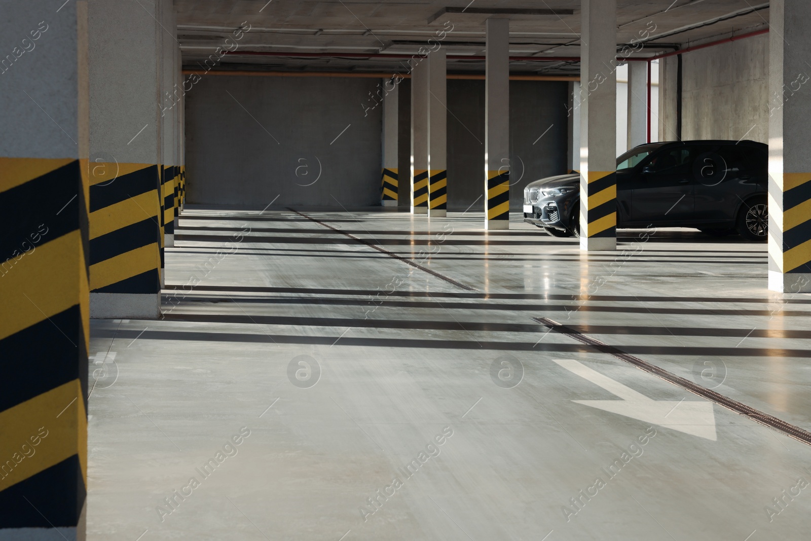 Photo of Open parking garage with car on sunny day