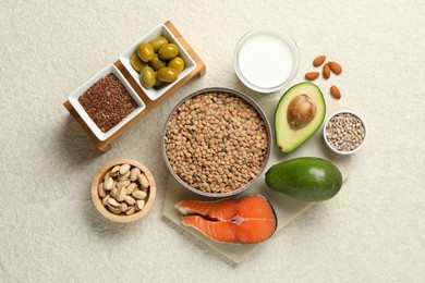 Photo of Different products high in natural fats on light table, flat lay